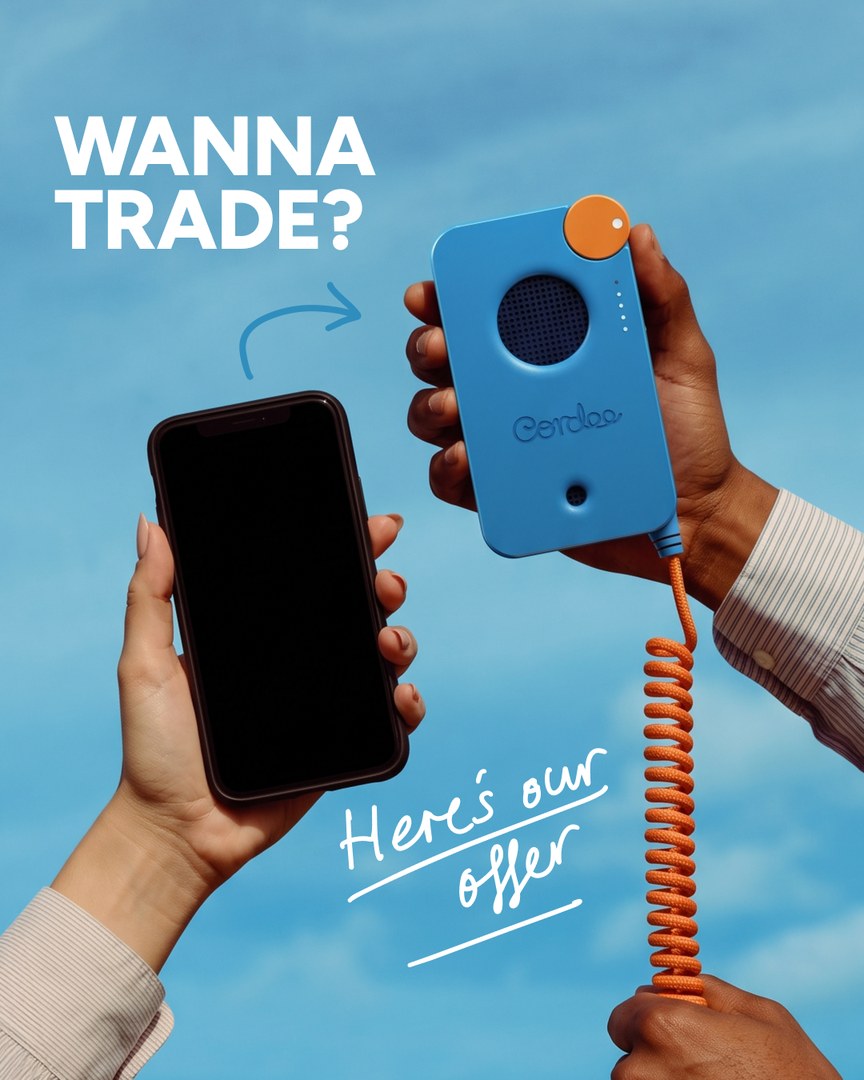 Wanna trade? A smartphone and a Cordee phone held up against the sky
